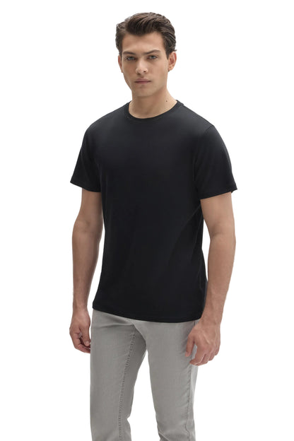 Man wearing a plain black crew neck short sleeve t-shirt with light gray pants