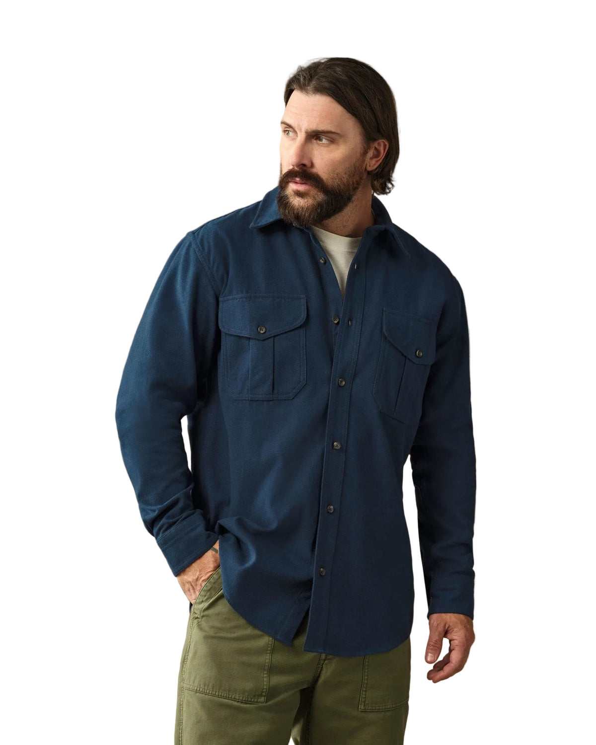 Man wearing navy blue moleskin button-up guide shirt with chest pockets and olive pants