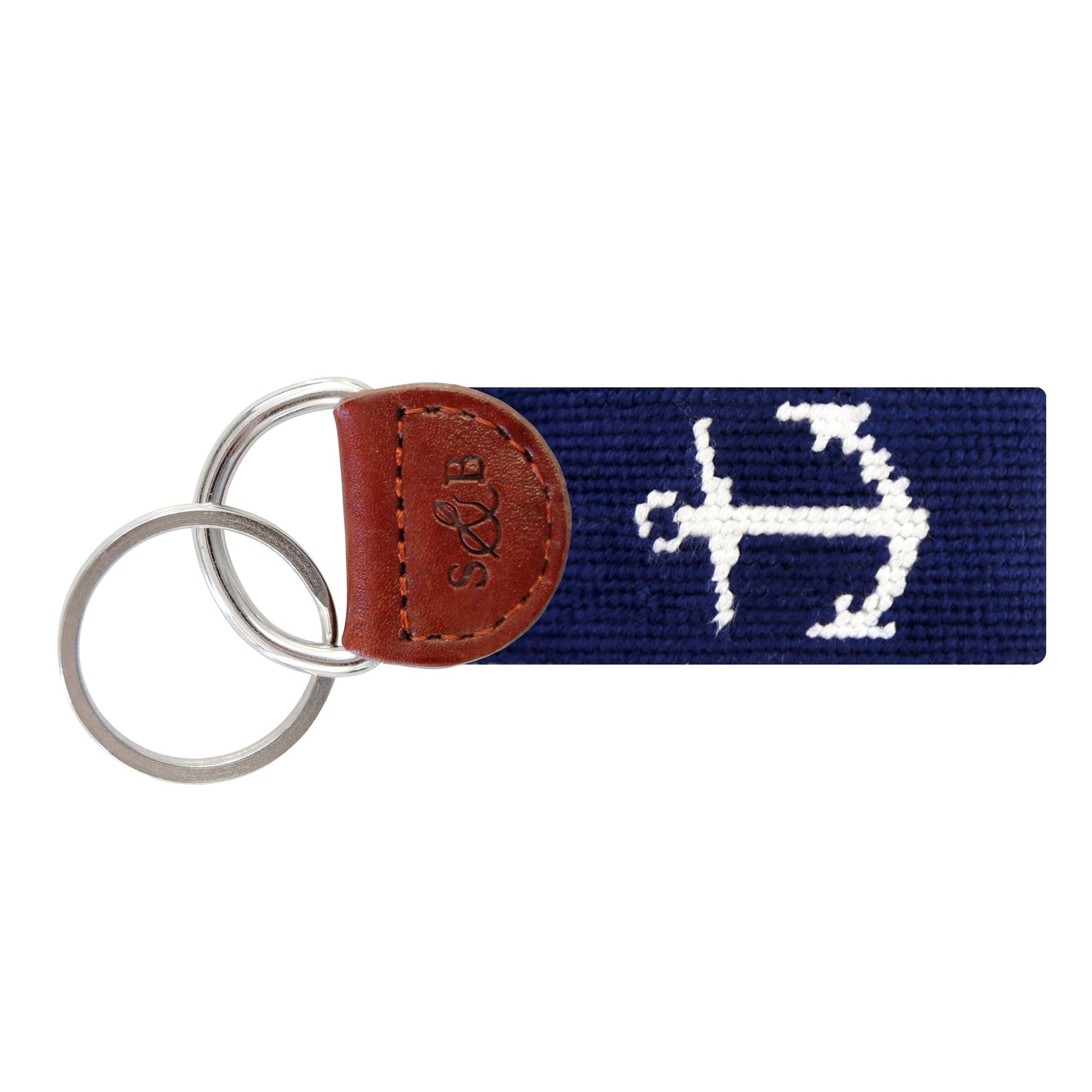 Navy blue needlepoint key fob with white anchor design and brown leather end