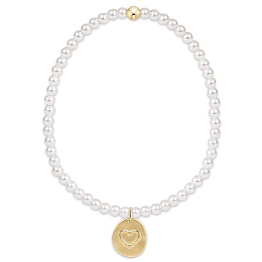White pearl beaded bracelet with gold heart disc charm and gold magnetic clasp