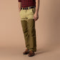 Two-tone tan and olive canvas briar pants with reinforced overlay panels and brown boots