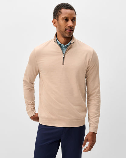 Men's beige quarter-zip pullover sweater with mock neck and navy pants