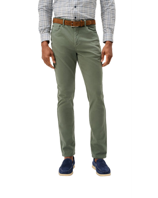 Olive green slim-fit sateen 5-pocket pants worn with plaid shirt and brown belt