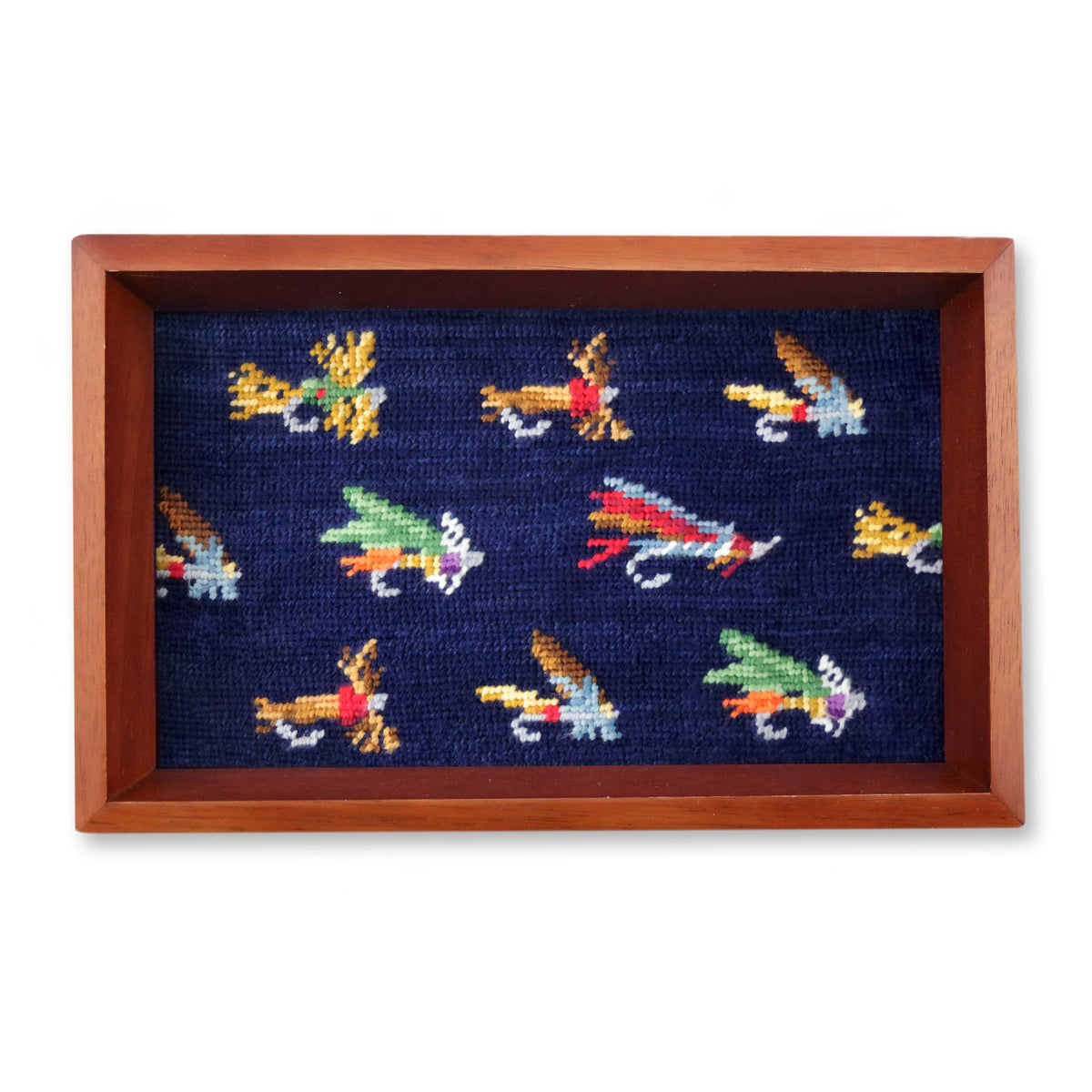 Navy needlepoint valet tray with colorful fly fishing lures in wood frame