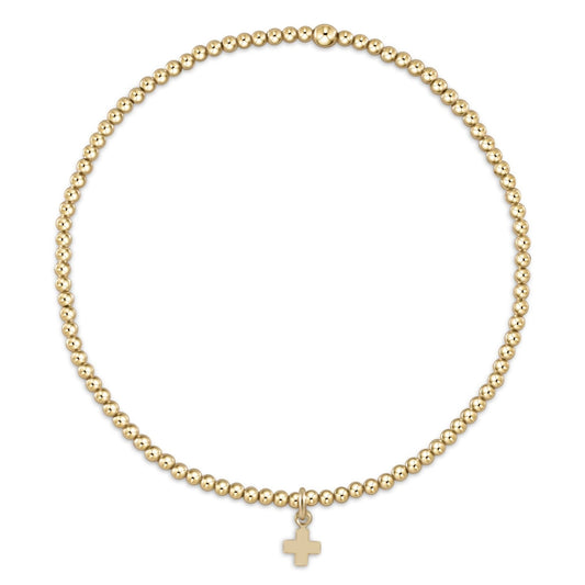 Gold beaded stretch bracelet with small gold cross charm pendant