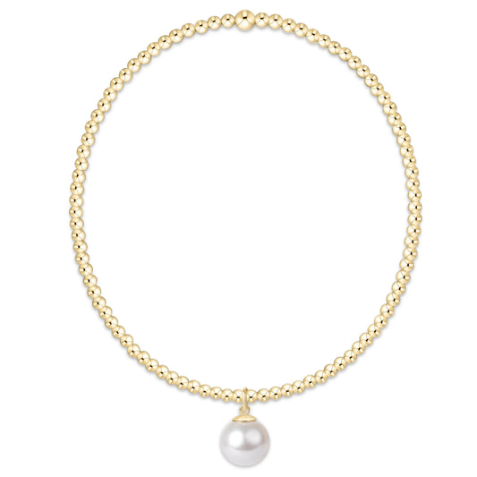 Gold beaded bracelet with single white pearl charm pendant on elastic band