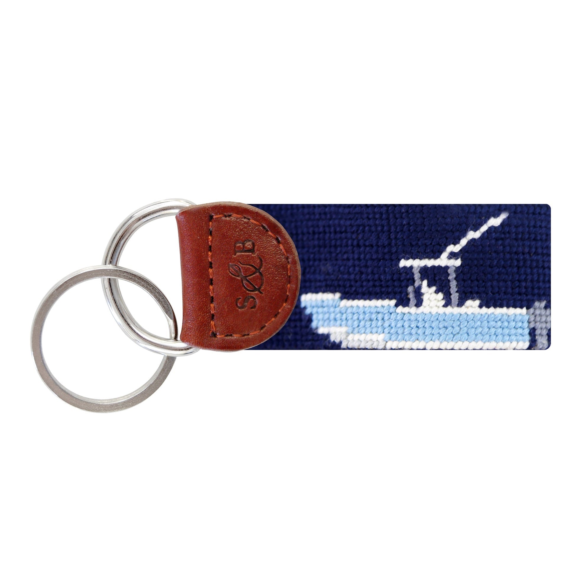 Navy needlepoint key fob with white power boat design and brown leather tab