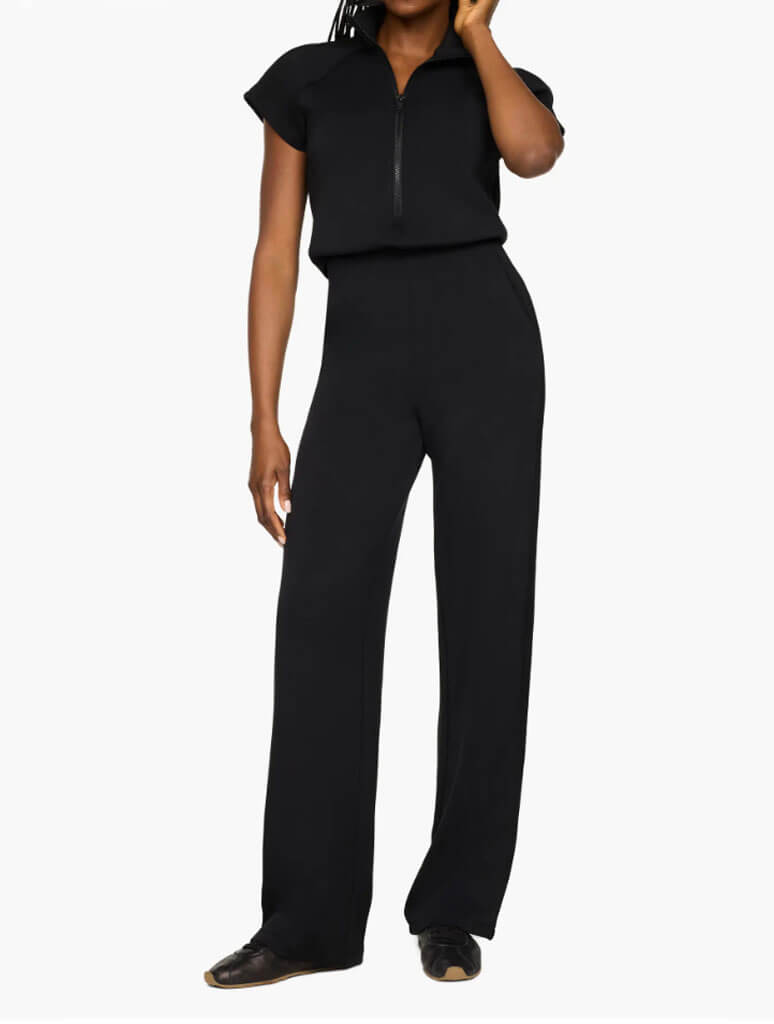 Women's black half-zip jumpsuit with wide-leg pants and short sleeves
