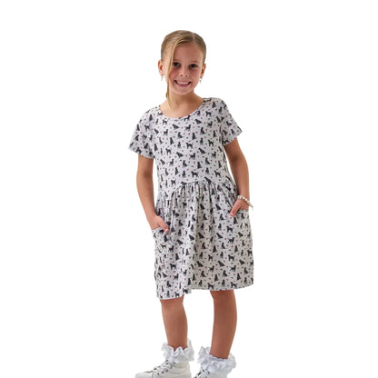Girl wearing light gray dog and duck print short sleeve dress with pockets