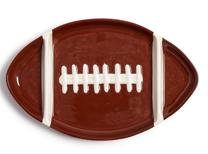 Football-shaped brown ceramic sectional serving platter with white lace detailing