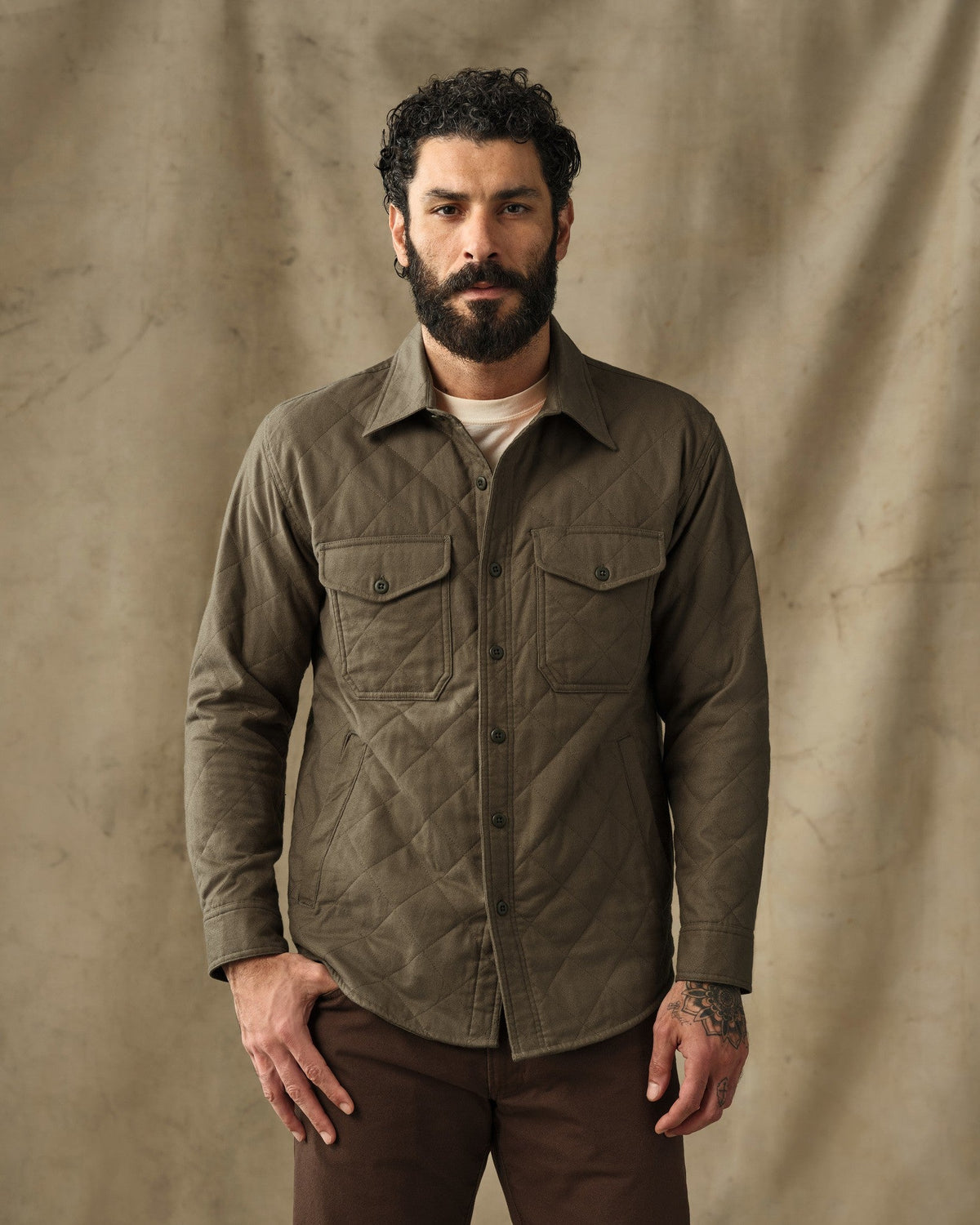 Men's olive green quilted flannel shirt jacket with dual chest pockets and button front