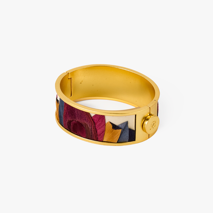 Gold hinged cuff bracelet with multicolor feather inlay in burgundy, navy, and gold