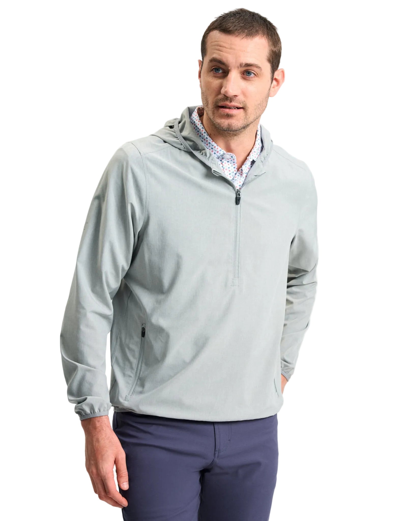 Men's light gray half-zip hooded performance shell pullover with blue pants