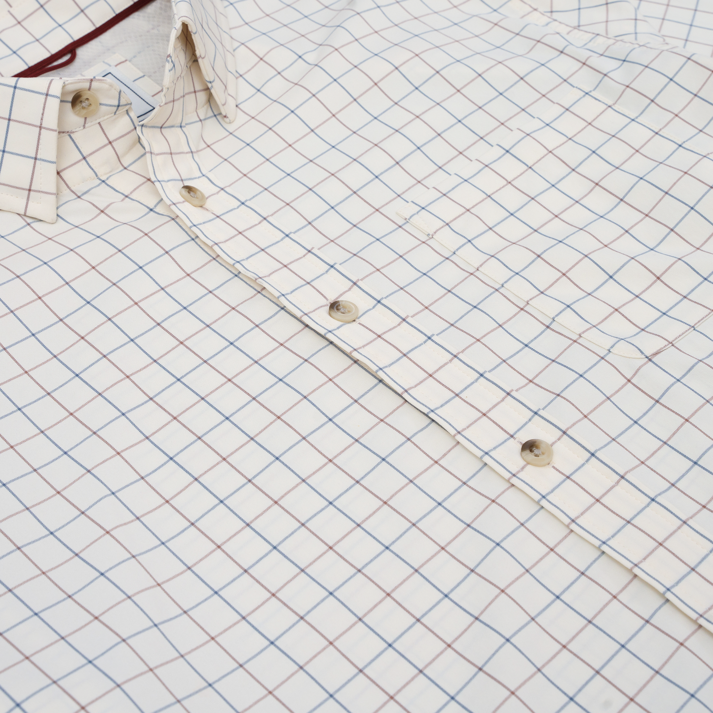 White button-down shirt with blue and maroon plaid check pattern, long sleeve