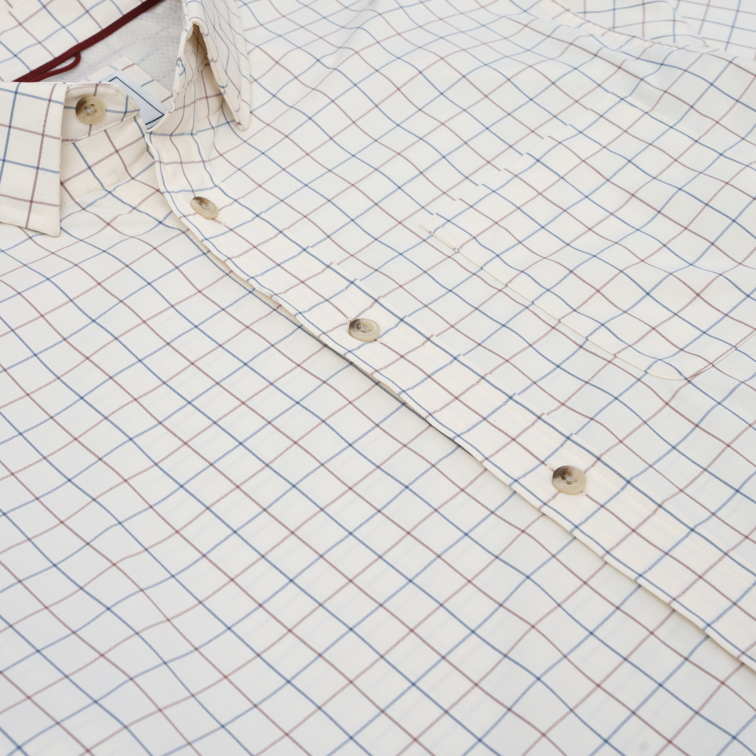 White button-down shirt with blue and maroon plaid check pattern, long sleeve
